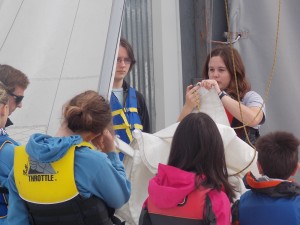 Olympia Yacht Club Junior Sailing Instructor Laura Smit (right) instructs campers on knot-tying skills as fellow instructor Liam Lloyd looks on (left).