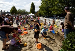 Families enjoy the huge sandbox at Sand in the City in downtown Olympia.  The event supports reduced admission programs at the Hands On Children's Museum.