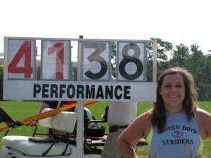 As a junior, Northwest Christian High School's Karen Bulger stands next to her winning distance in the javelin  (in meters) at the National Junior Olympics in Baltimore, which was 135’9”.