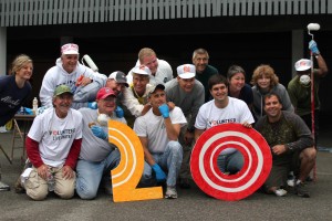 Volunteers assembled by City of Olympia employees gather to paint and install new lighting in the parking area at First Christian Church in downtown Olympia. Photo by Jennifer Crain.