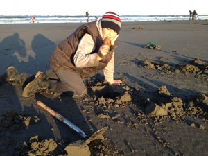 Jim Boora's son pulls up a razor clam during a glorious dig on Mocrocks.  