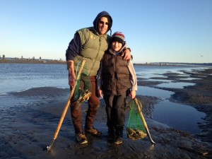 Jim Boor and his son display their limit of 15 razor clams dug along Washington's coastal beaches.