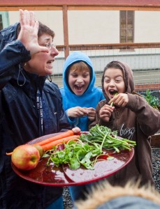 Kids rejoice with the vegetables harvested from the garden.