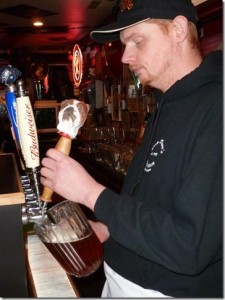 A bartender at Dirty Dave's Pizza pours a Bull Dog Ale.