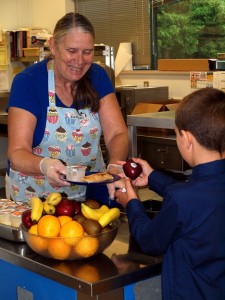 Pioneer Elementary School’s Melinda Schori serves delicious breakfast burritos, juice and fruit with a smile.