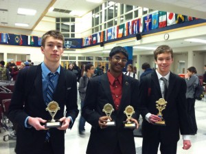 Nick Harrison, Sampath Duddu, and Max Harrison display their trophies after a win at Federal Way High School last spring.