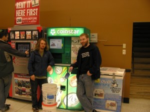 Michael Walther and Paxton Rice use a Coinstar machine to donate coins collected at Griffin School to UNICEF.