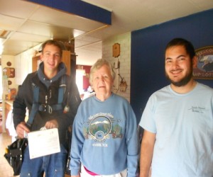 South Sound Solar employees Brian Jones and Daniel Kuni with homeowner Carol Sowers.