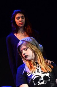 Molly Ellenbecker as Ali (sitting) and Sofia Sanchez-Muir as Megan in "American Roulette" produced by Theater Artists Olympia in conjunction with Animal Fire Theater.