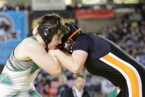 Senior Megan Johnson of Tumwater digs into freshman Abby Lees of Washougal. After a match with the majority of the three rounds spent grappling on their feet, Johnson eventually took control with a 6-2 win.