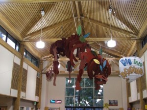 The Lacey Timberland Library branch offers an engaging and welcoming area for children and youth.  A giant dinosaur sculpture hangs from the ceiling, just one example of the libraries’ efforts to create a fun and engaging, youth-friendly atmosphere.  Photo credit: Gale Hemmann