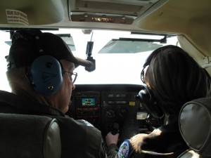 Major Richard Stack (left) mentors Cadet Felts (right) as she prepares to bank the aircraft. Source: South Sound Composite Squadron 