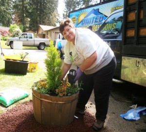 Cathy Johnson, owner of Dandelion Gardens, sprucing up old planters on National Rebuilding Day.