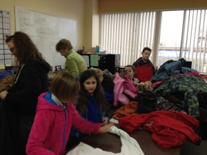 Student Council members sort coats from Serendipity Academy's winter coat drive with One Warm Coat.