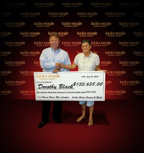 Lucky Eagle Casino & Hotel CEO John Setterstrom presents Dorothy Black of Olympia, Wash. with a check for $133,639. She won the jackpot playing Bingo at the casino on July 29.  – Photo courtesy of Lucky Eagle Casino & Hotel.