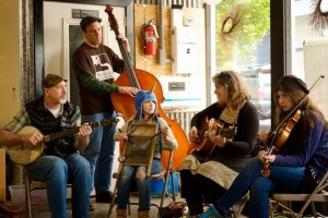 Family stringband Fiddlie-I-Ay welcomes visitors to Arbutus Folk School at Spring Arts Walk 2014 in downtown Olympia, sponsored by City of Olympia Parks, Arts & Recreation and the Olympia Arts Commission. Photo courtesy City of Olympia.