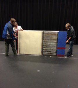 The set design crew hard at work mapping out plans for the set using recycled set pieces.