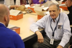 Dick Kay listens as friends tell stories during his retirement party last week.