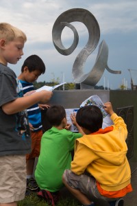 Young art enthusiasts from City of Olympia’s Camp Olywahoo check out Full Curl by Rodger Squirrell, part of the 2014 Percival Plinth sculpture exhibition.  Photo courtesy City of Olympia.   