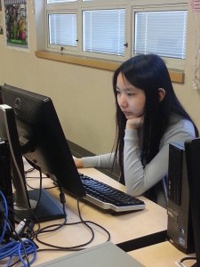 Dot Diva member Jessica Giang works on programming during one of the club's meetings. 