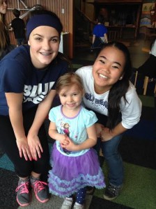 Jessica McGregor (left) and Hope Dorris smile with their preschool buddy Madison at Hands On Children's Museum.