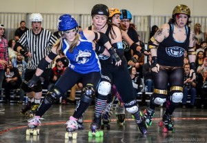 Rebecca Parvin (star cap) shrugs off a hit at a recent bout. Photo credit: Regularman Photography