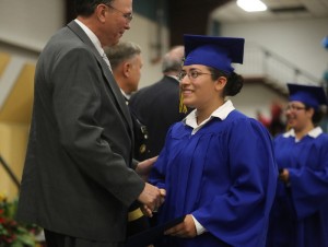 Cadet Cavazos of Lacey smiles and shakes the hand of Washington Youth Academy Director Larry Pierce during commencement ceremonies on June 20.