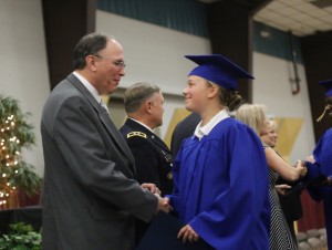 Cadet Knox of Olympia smiles and shakes the hand of Washington Youth Academy Director Larry Pierce during commencement ceremonies on June 20.