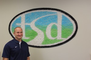 Chris Woods is Tumwater School District’s new Executive Director of Student Learning. He is seen here in his new office with the art-work of former student Emily Hauge.