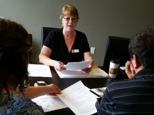Cheryl explains the purchase and sale agreement to new home buyers.