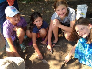 Evergreen students lead kids in an archeology dig at the Bush Homestead in Tumwater.