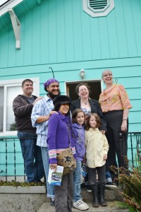 The Gooze family at their new home pose with partners that helped them get there.  
