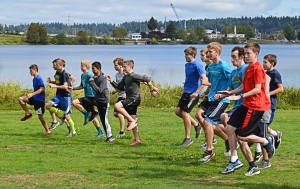 The Northwest Christian’s boys’ cross country team warms up prior to a run around Capitol Lake. 