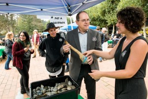 The new president of The Evergreen State College, George Bridges, is welcomed by students and the school mascot, the Geoduck. Photo by Shauna Bittle, The Evergreen State College
