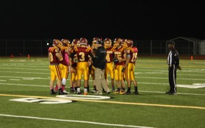 Soderberg (no. 3) and the CHS Cougar team have a chat with Coach Johnson