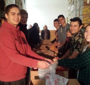 DECA students help sort donations at the Thurston County Food Bank.