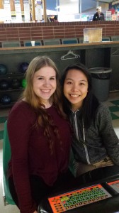 Kassidy Tromboni and Tina Pham watch team members bowl during practice and wait for their turn.