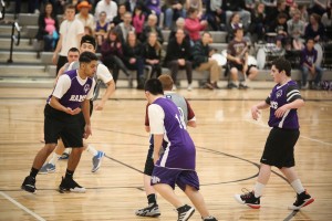Students Gabriel Smith, Marcus Tollefson, and Trevin Durham work hard during a North Thurston Unified Basketball game.