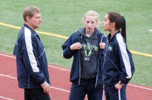 Coach Michael spends time strategizing with his runners before their race.