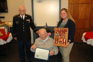 Darld Brannan (left) poses with retired Col. Thomas Fitzgerald (seated) and Fitzgerald's daughter, Sarah, following the pining ceremony.  Photo courtesy: Providence.