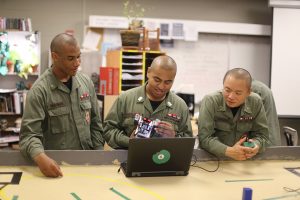 Patrick Burgman of Olympia (left) works with Eros Gonzales of Lynden and Raymond Saechao of Vancouver on a robotics project at the Washington Youth Academy. Photo courtesy: Washington Youth Academy.