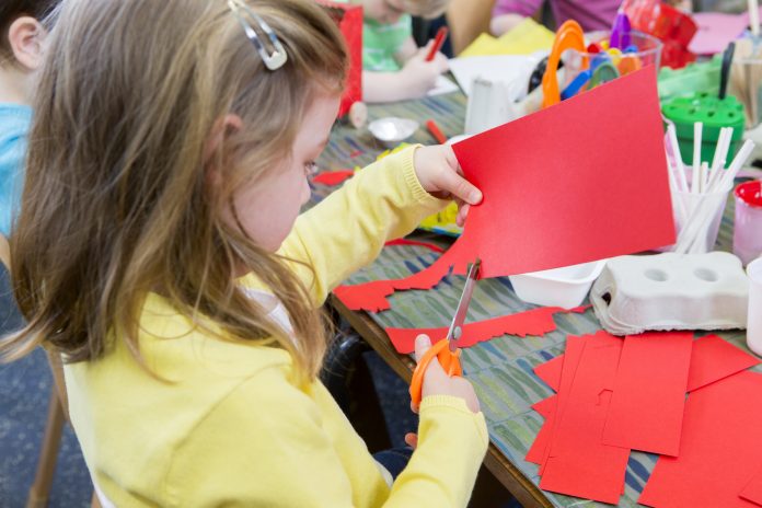 Little Girl Cutting Paper