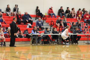 Phil Degon announces the name of another player coming into the game. Photo credit:Gail Wood