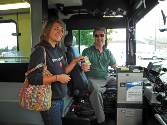 Driver with boarding passenger Intercity Transit Bus Pass