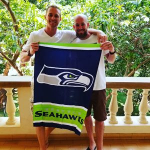 Zack Forbush and Kris Ammons Kris and Zack Seahawks Flag in Tanzania