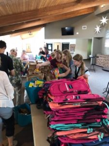 Volunteers Packing Backpacks