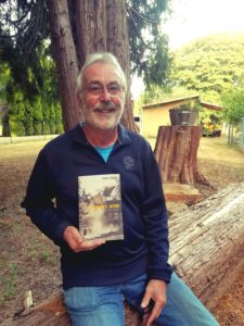 John Dodge Deadly Winds Holding his Book at his farm