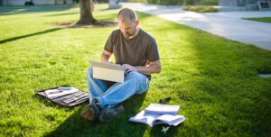 Comcast Veteran on Laptop Sitting in the Grass