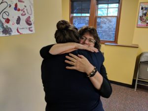 South Sound Parent to Parent Kim Smith hugging an employee