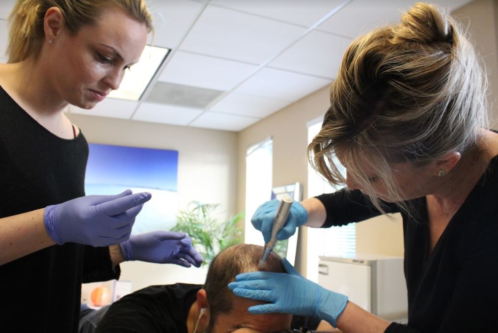 Omni Esthetics Employees Working with a Patient